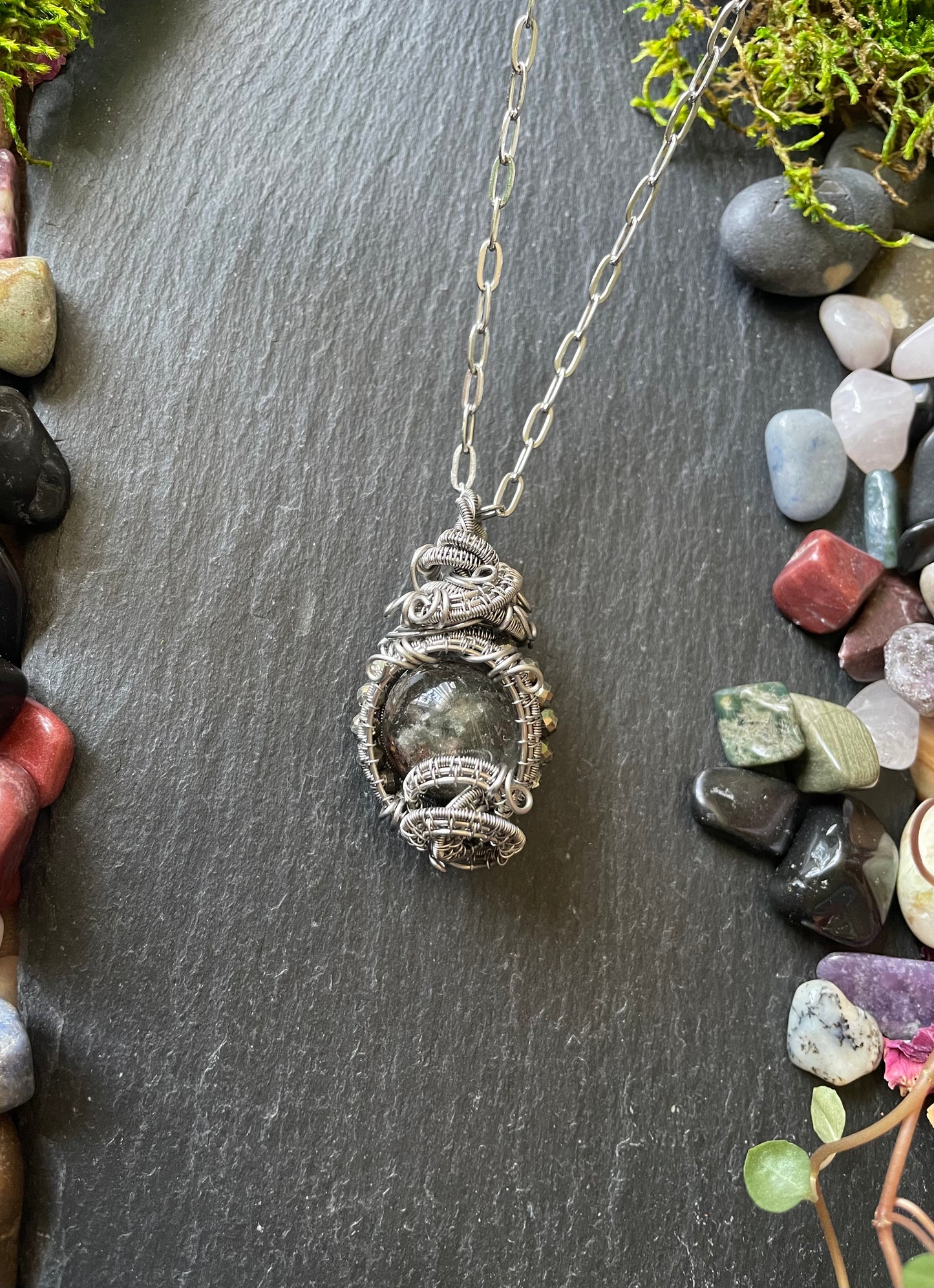 Image of a crystal ball amulet with garden quartz sphere and pyrite beads