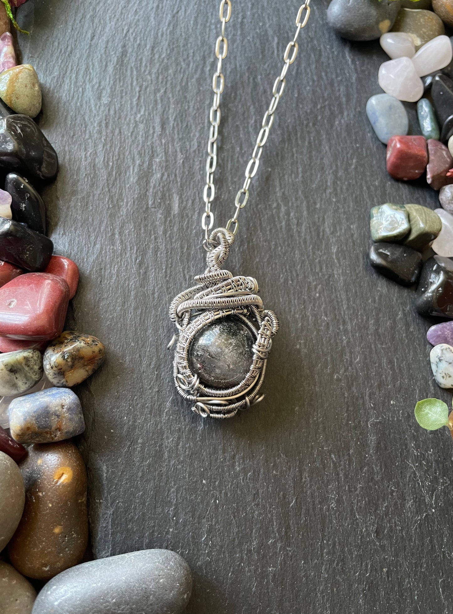 Image of a crystal ball amulet with garden quartz sphere