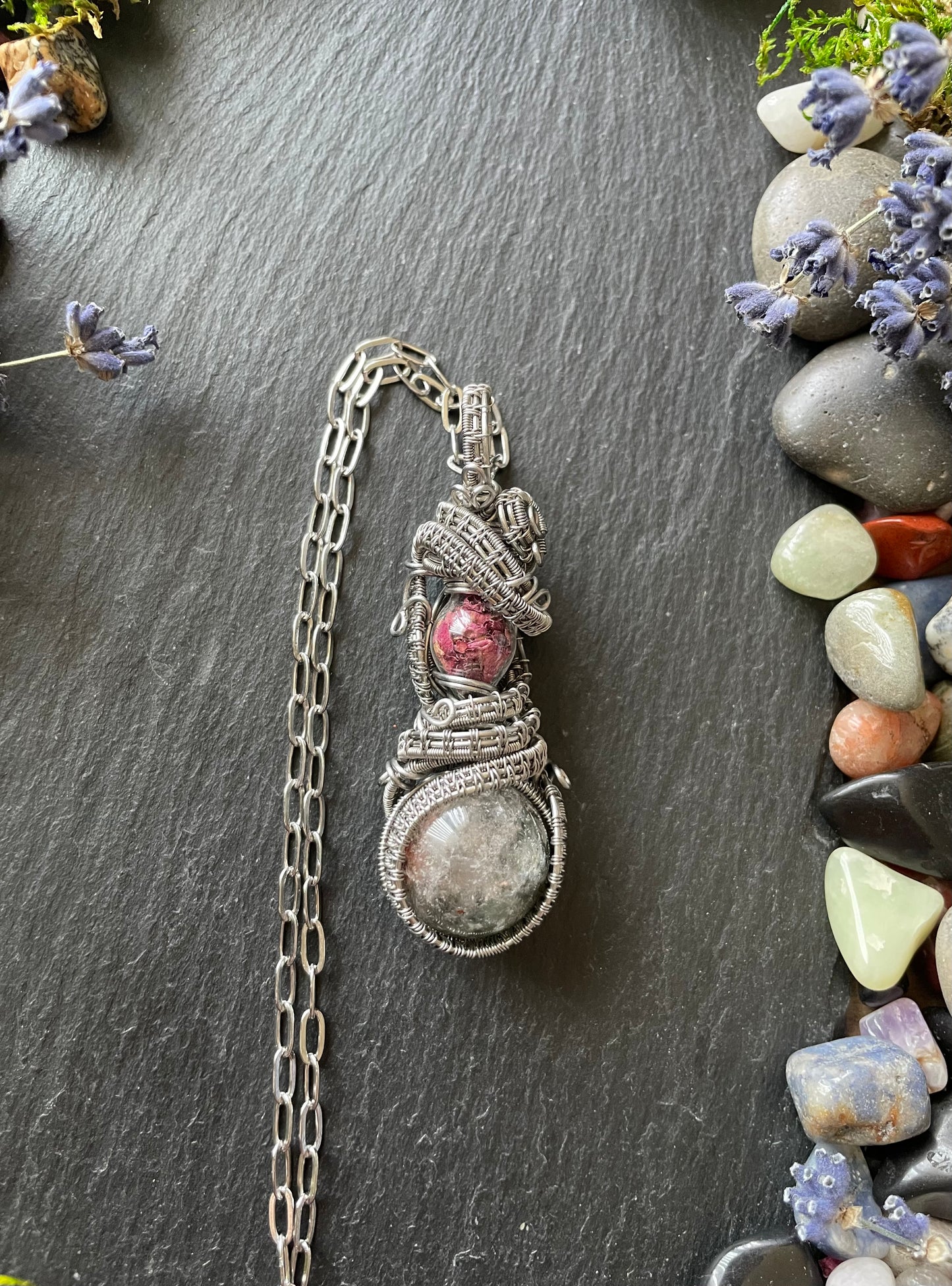 A magic crystal ball amulet with chlorite quartz sphere and rose petal filled glass vial