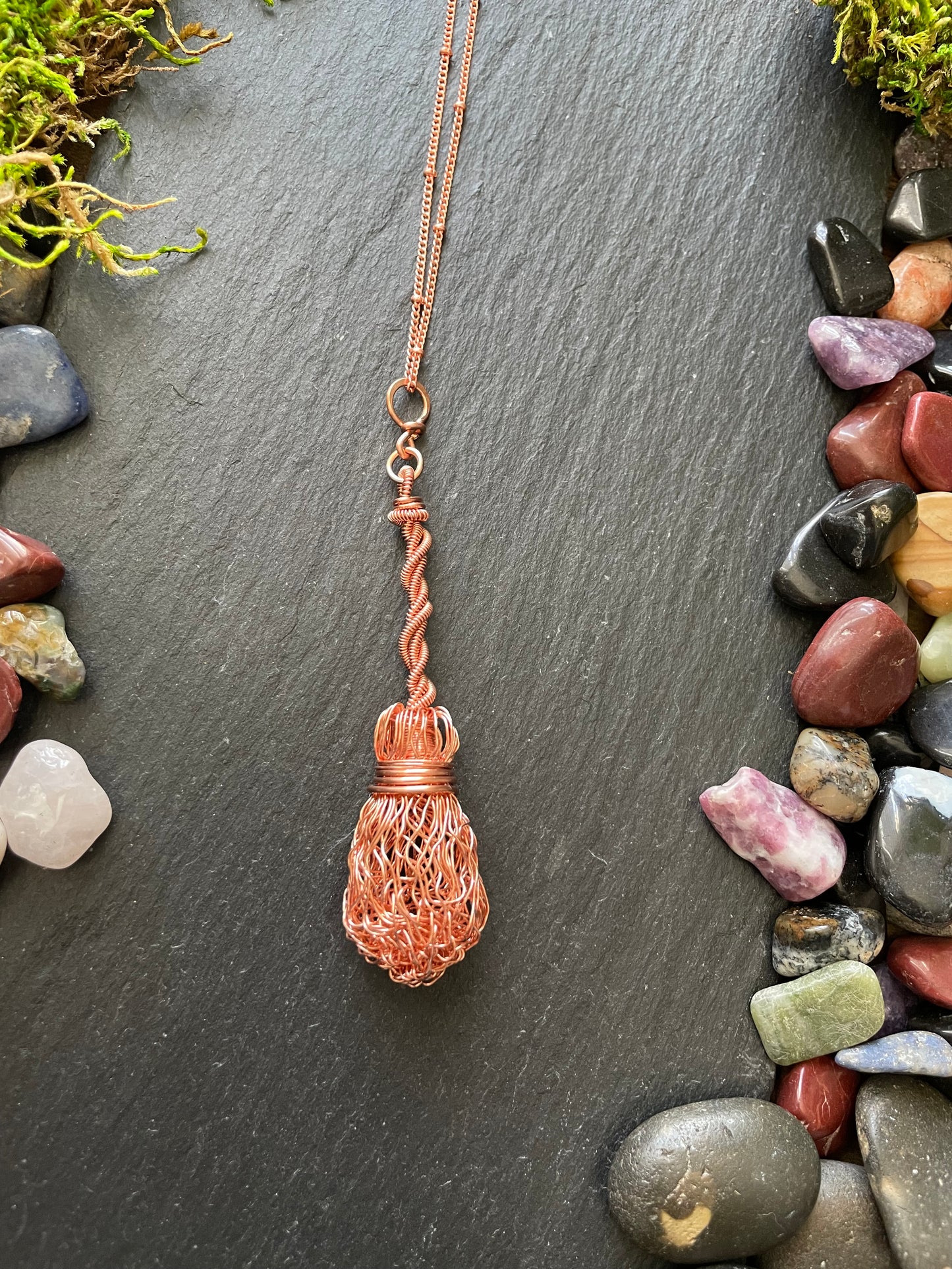 Image of bright copper witch broom pendant with twisted handle