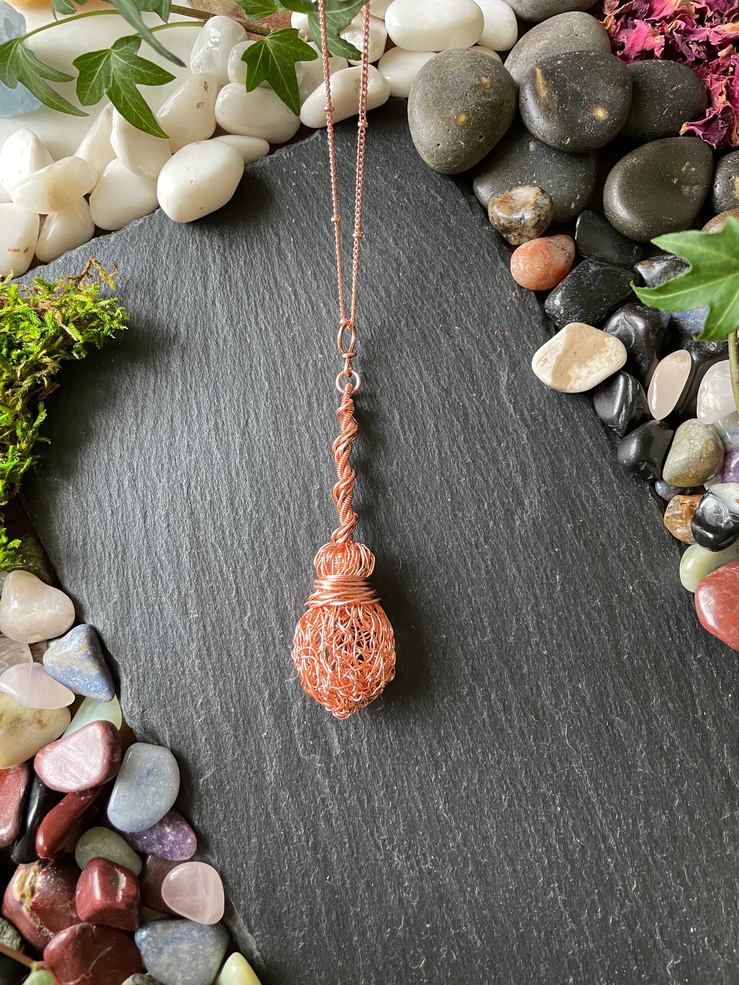 Image of bright copper miniature witch broom pendant with twisted handle