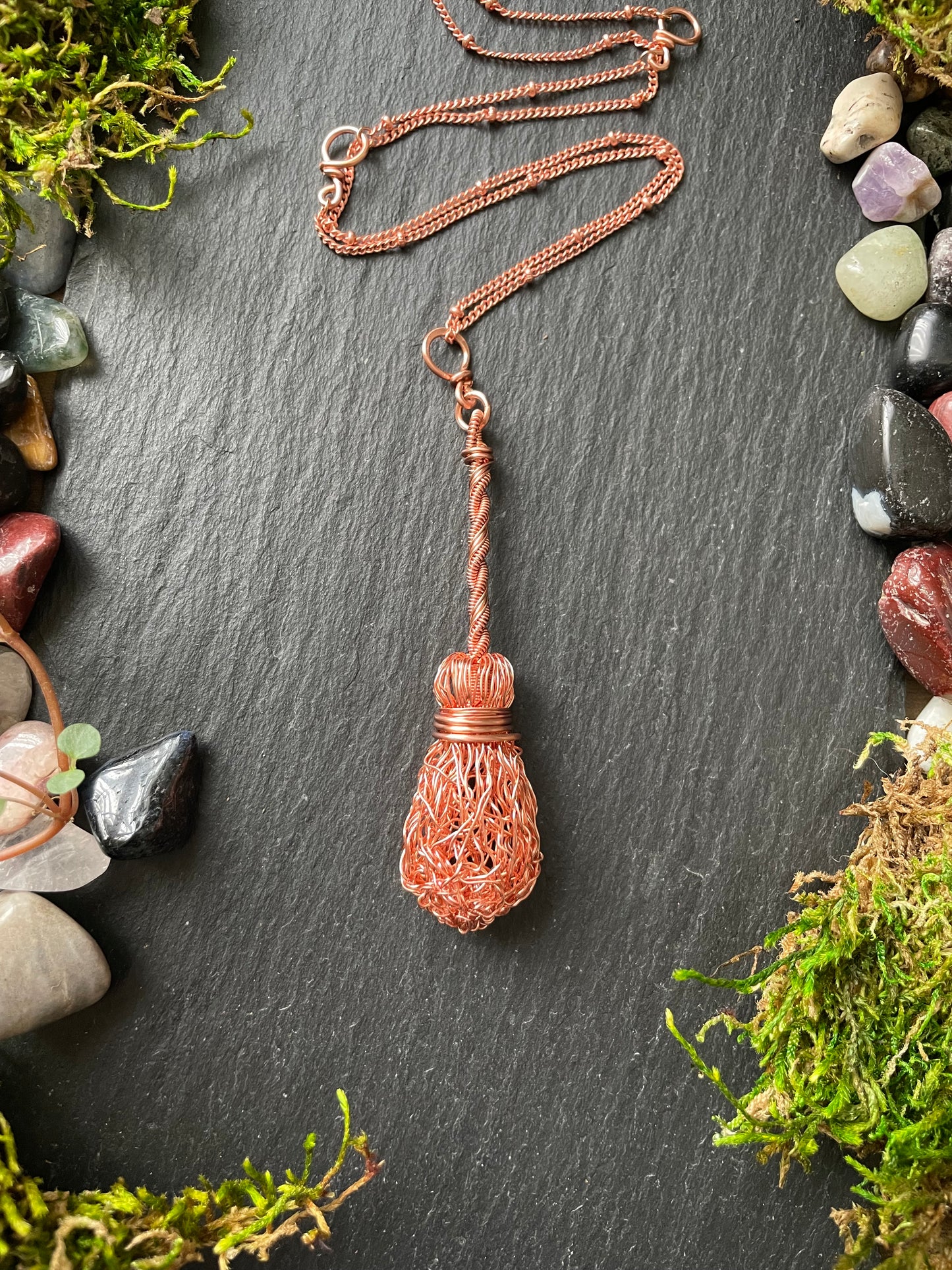 Image of a miniature broom pendant made of wire