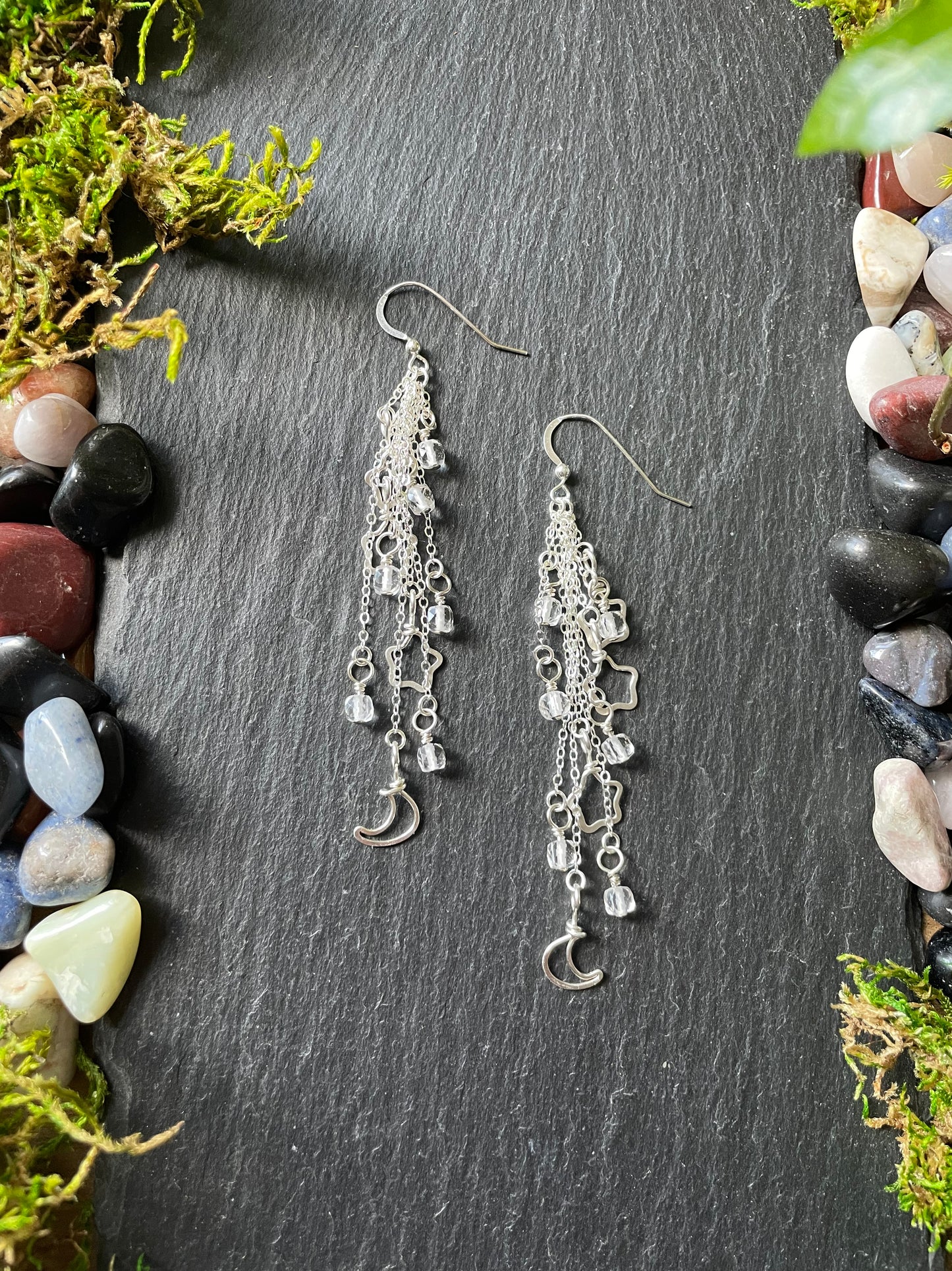 Image of sterling silver celestial dangle earrings with star and moon charms