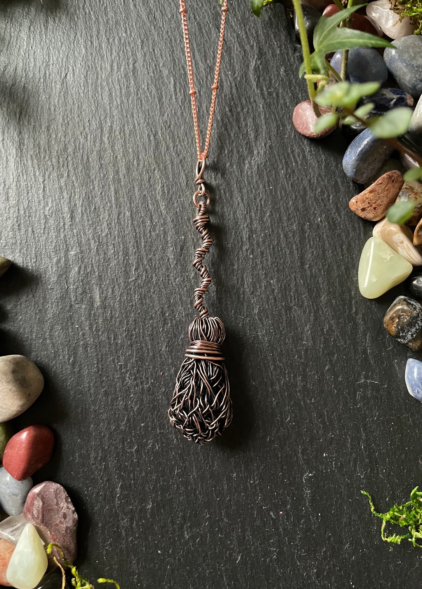 Image of a miniature broom pendant made of wire
