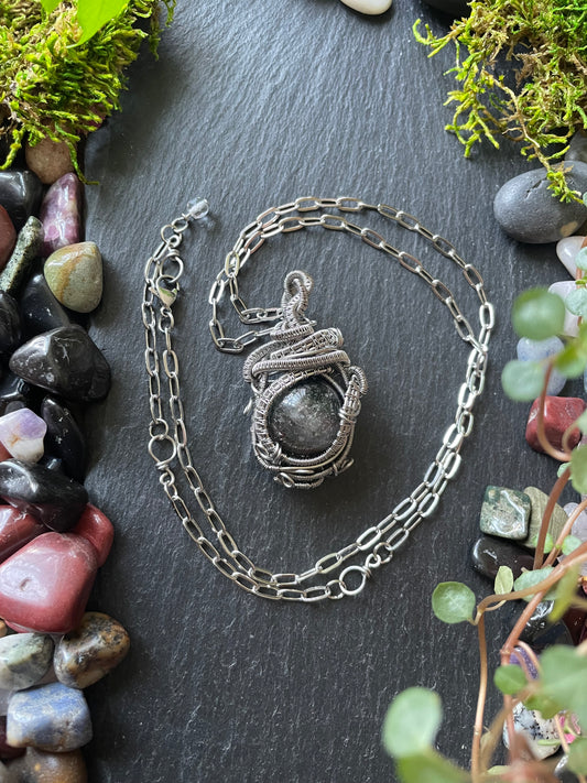 Image of a crystal ball amulet with chlorite quartz sphere