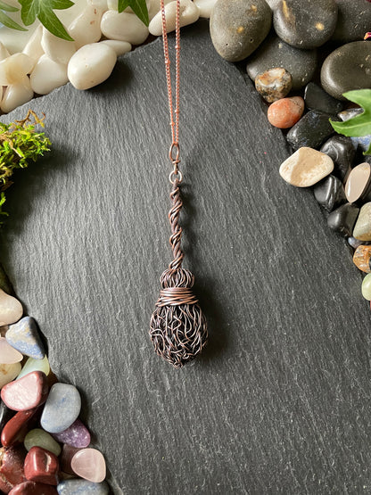 Image of an antiqued copper miniature witch broom pendant with twisted handle