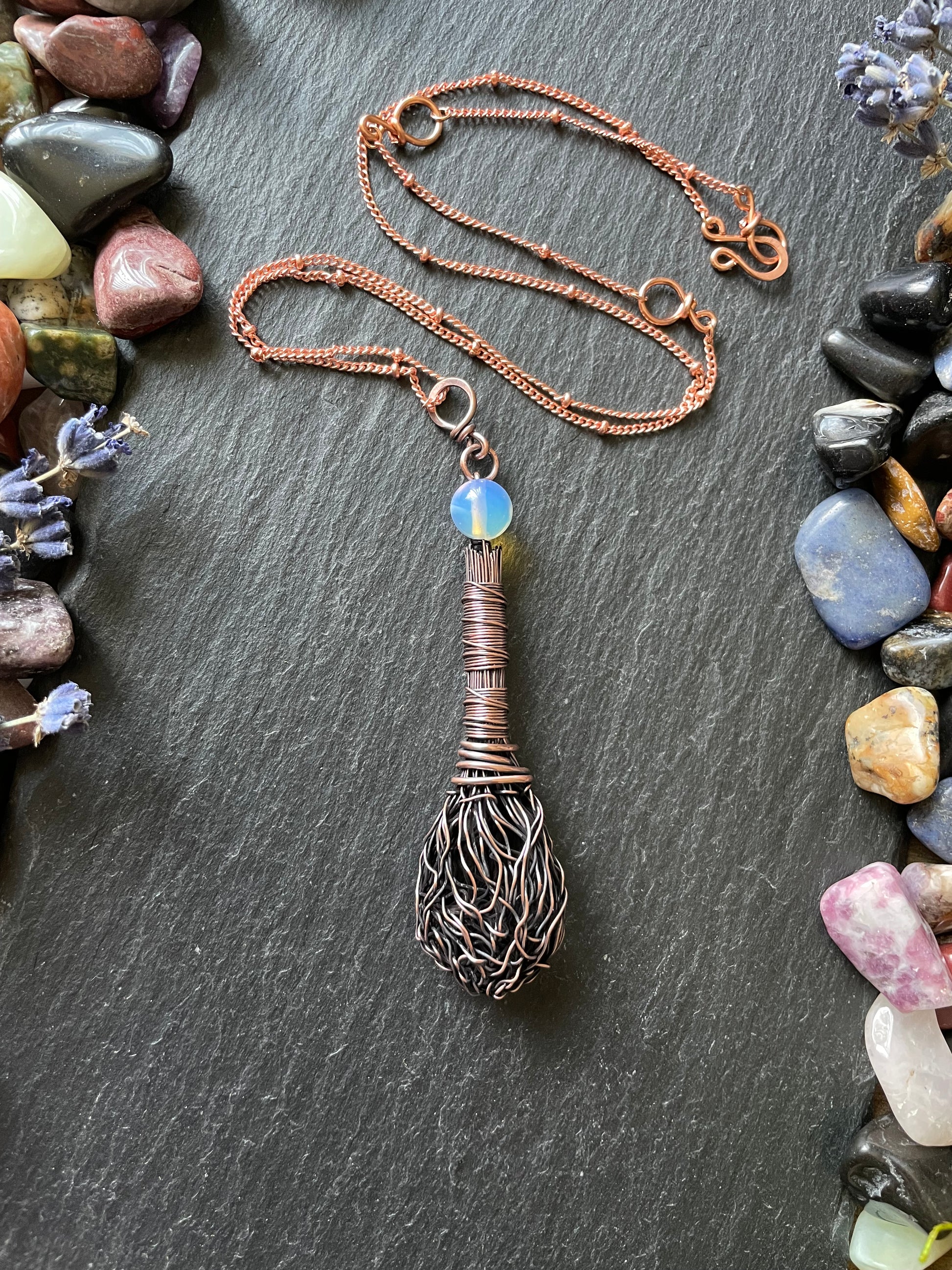 Miniature antiqued copper broom with wire wrapped handle and an opalite bead topper, attached to a matching copper chain