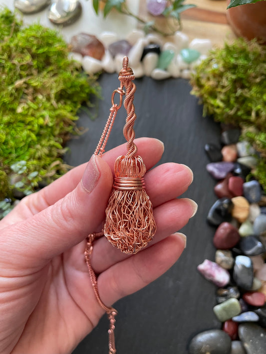 Image of bright copper wire broom pendant with twisted handle