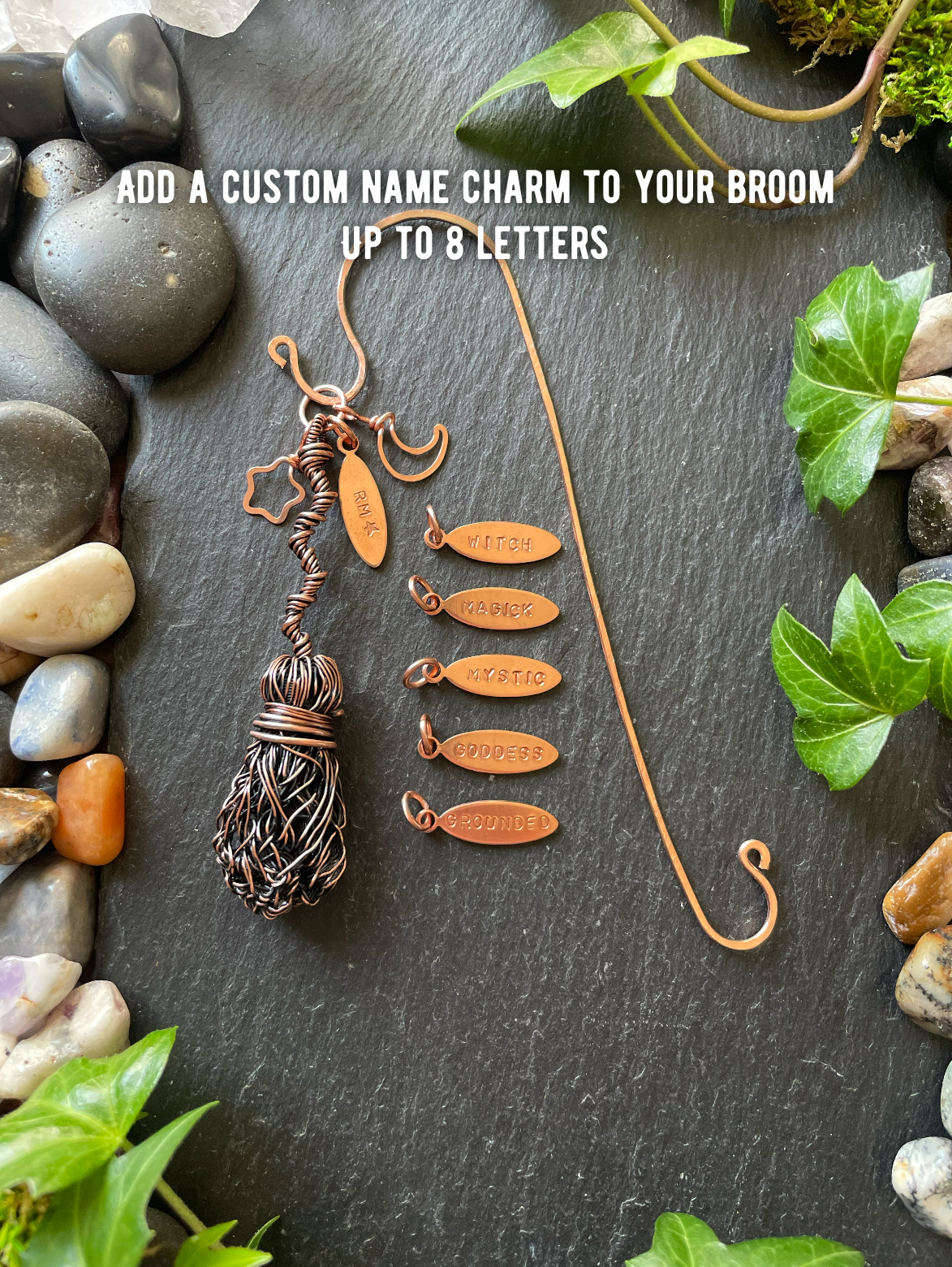 Decorative broom with customizable name charm on a stone and greenery background