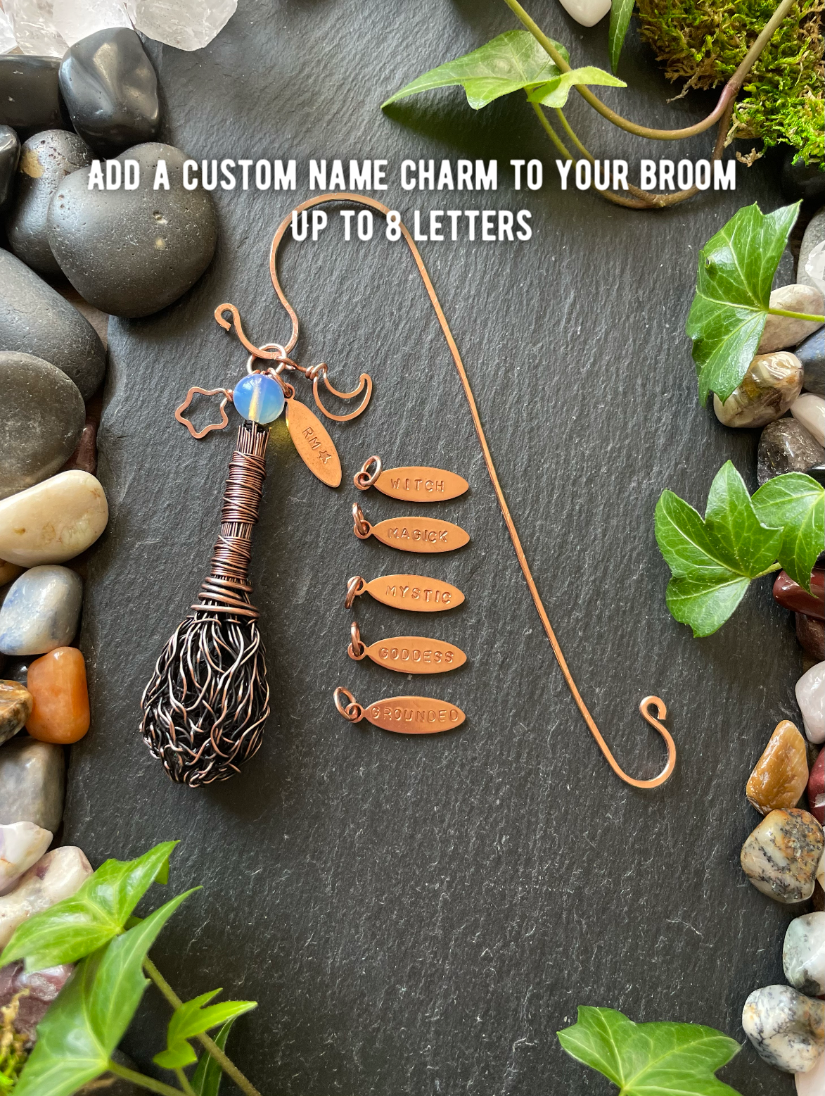 Decorative broom with customizable name charm on a stone and leaf background