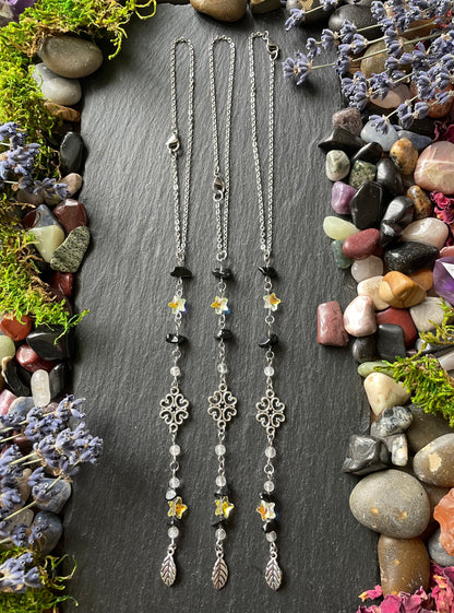 Three crystal car charms with obsidian and star beads, with silver leaf charms