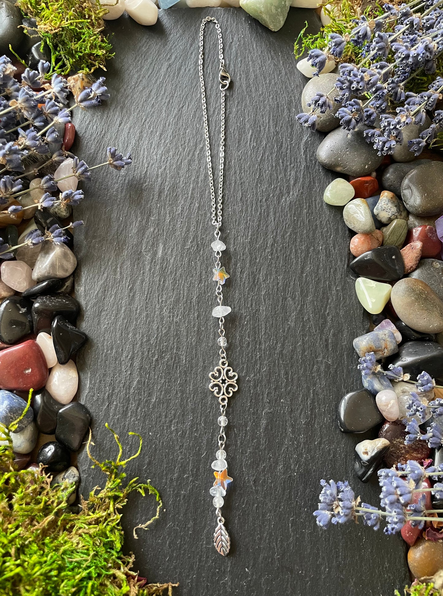 A magic car charm with quartz crystal beads, star charms, and a leaf charm