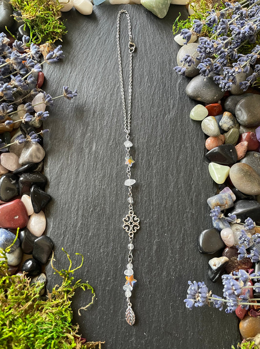 A magic car charm with quartz crystal beads, star charms, and a leaf charm
