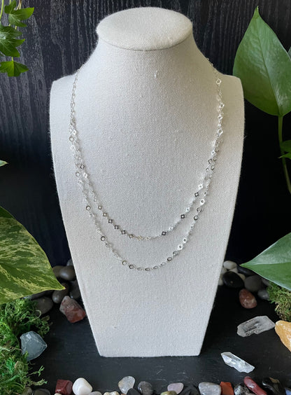 Necklace on a mannequin bust with a natural stone and leaf background