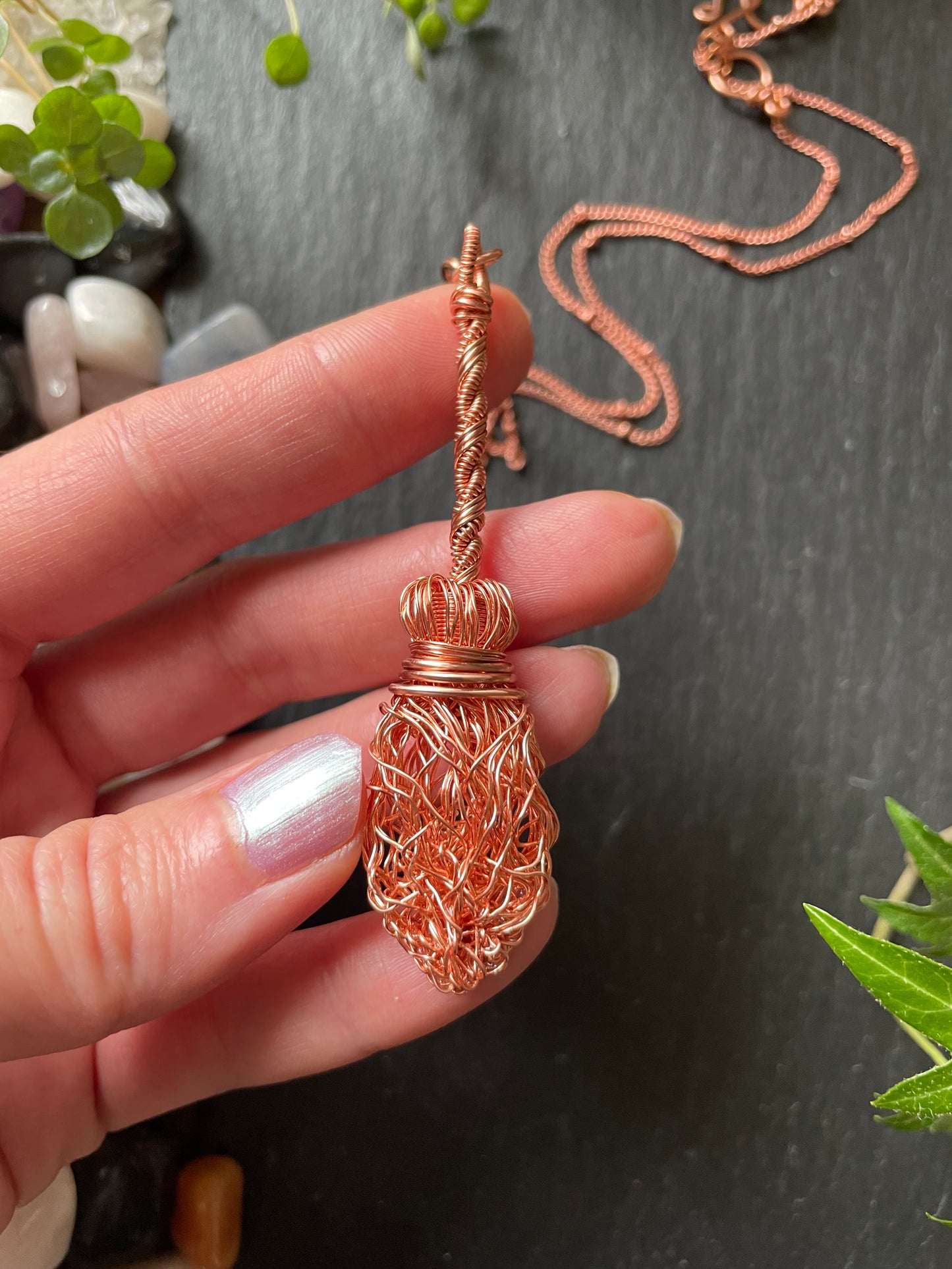 Image of a miniature broom pendant made with copper wires