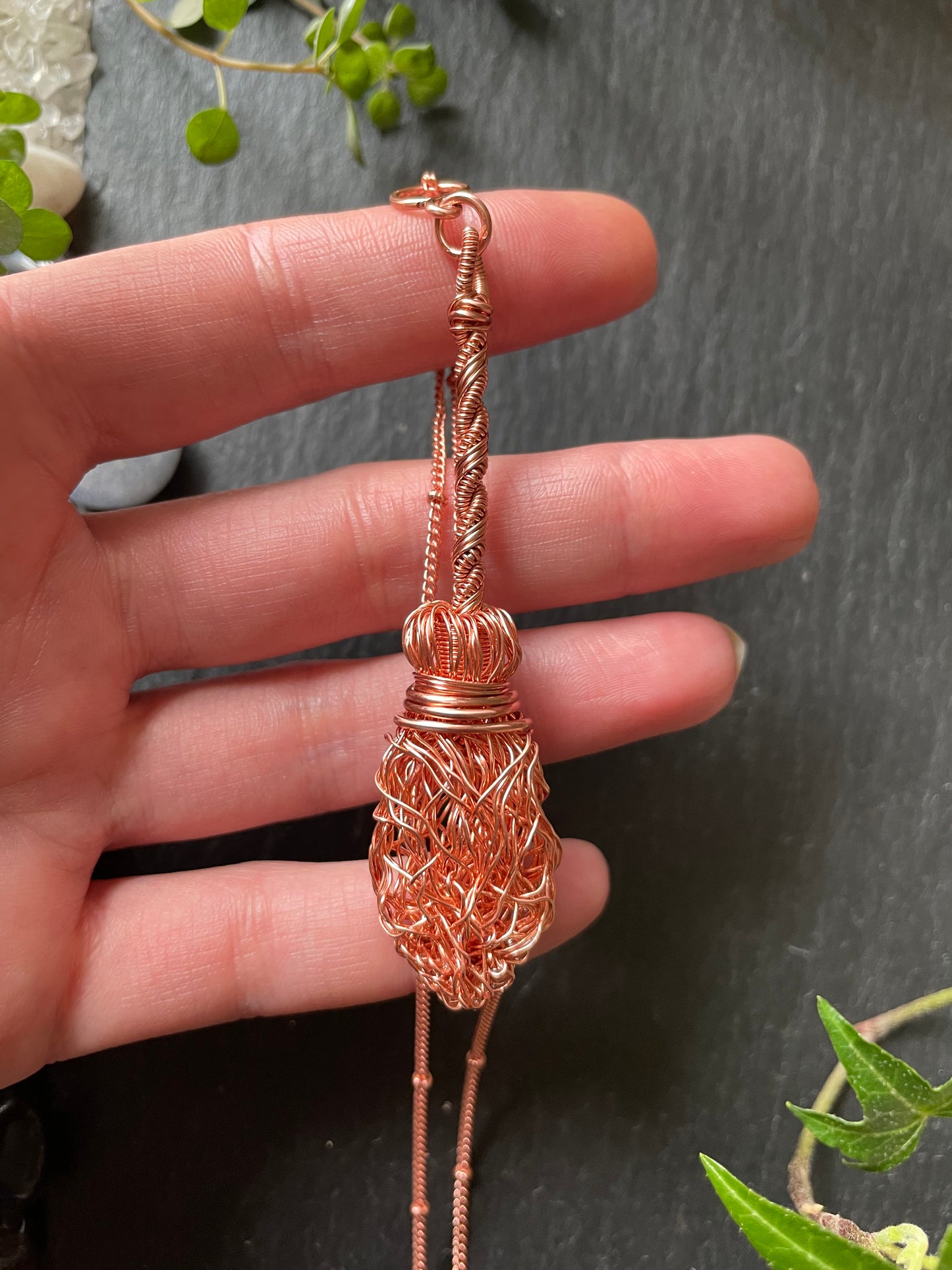 Image of a miniature broom necklace made with copper wires