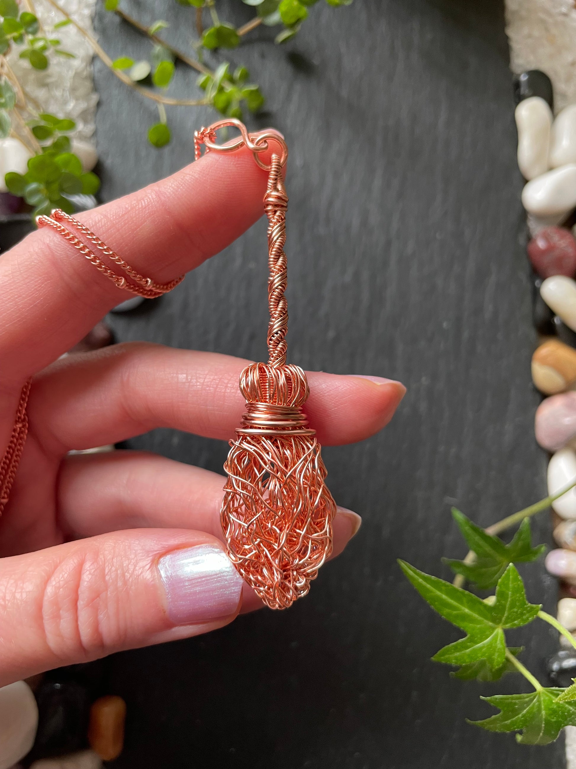 Image of a miniature broom necklace made with copper wires