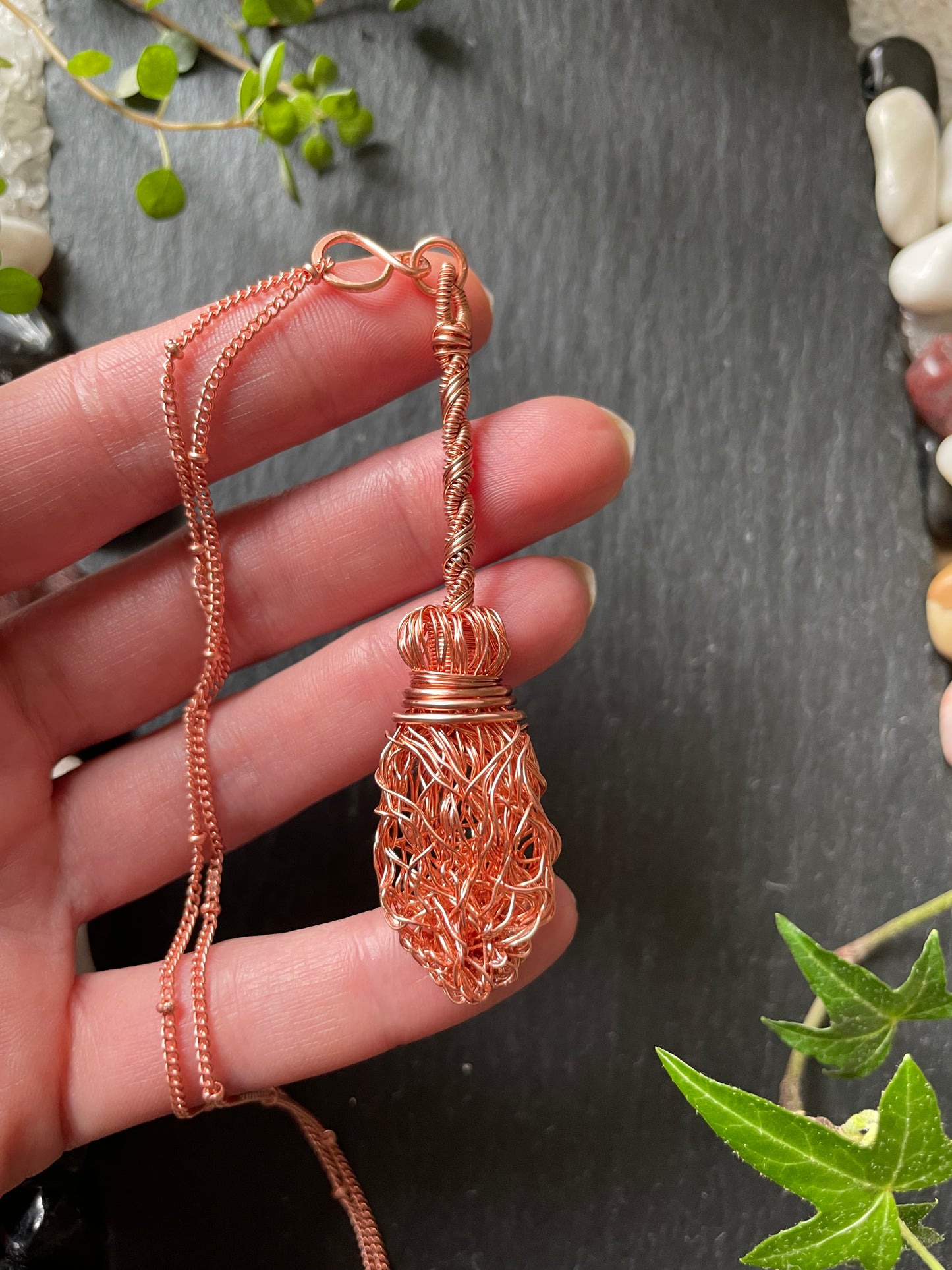 Image of a miniature broom made of copper wires