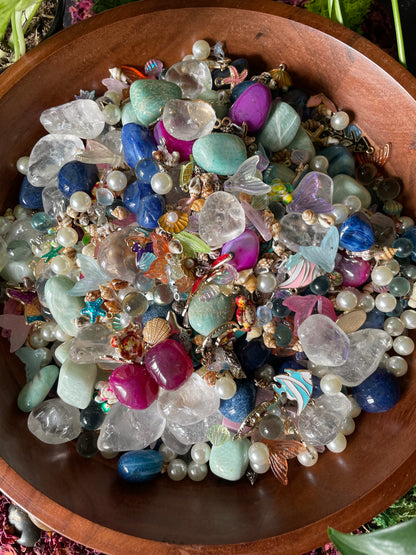 Assorted colorful gemstones in a wooden bowl