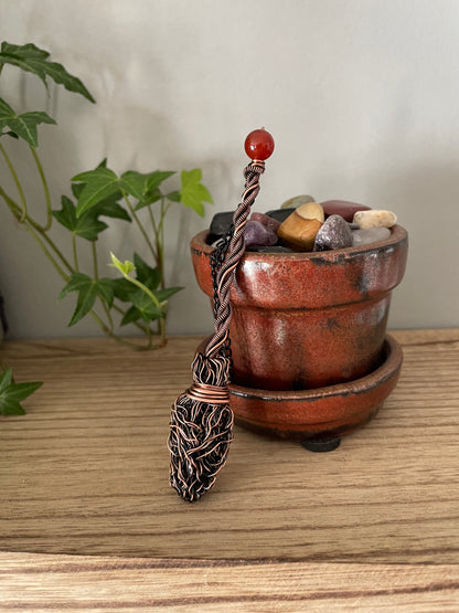 Image of miniature copper broom with carnelian bead