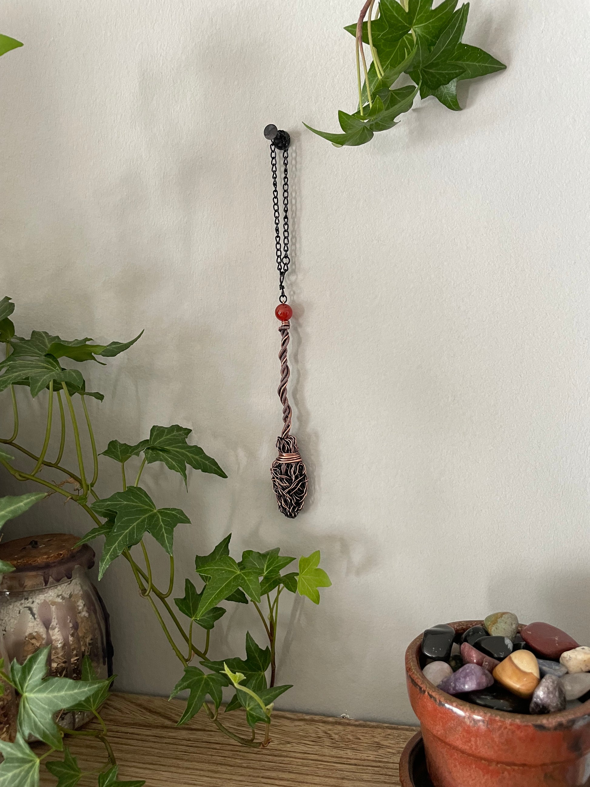 Image of miniature copper broom with carnelian crystal bead