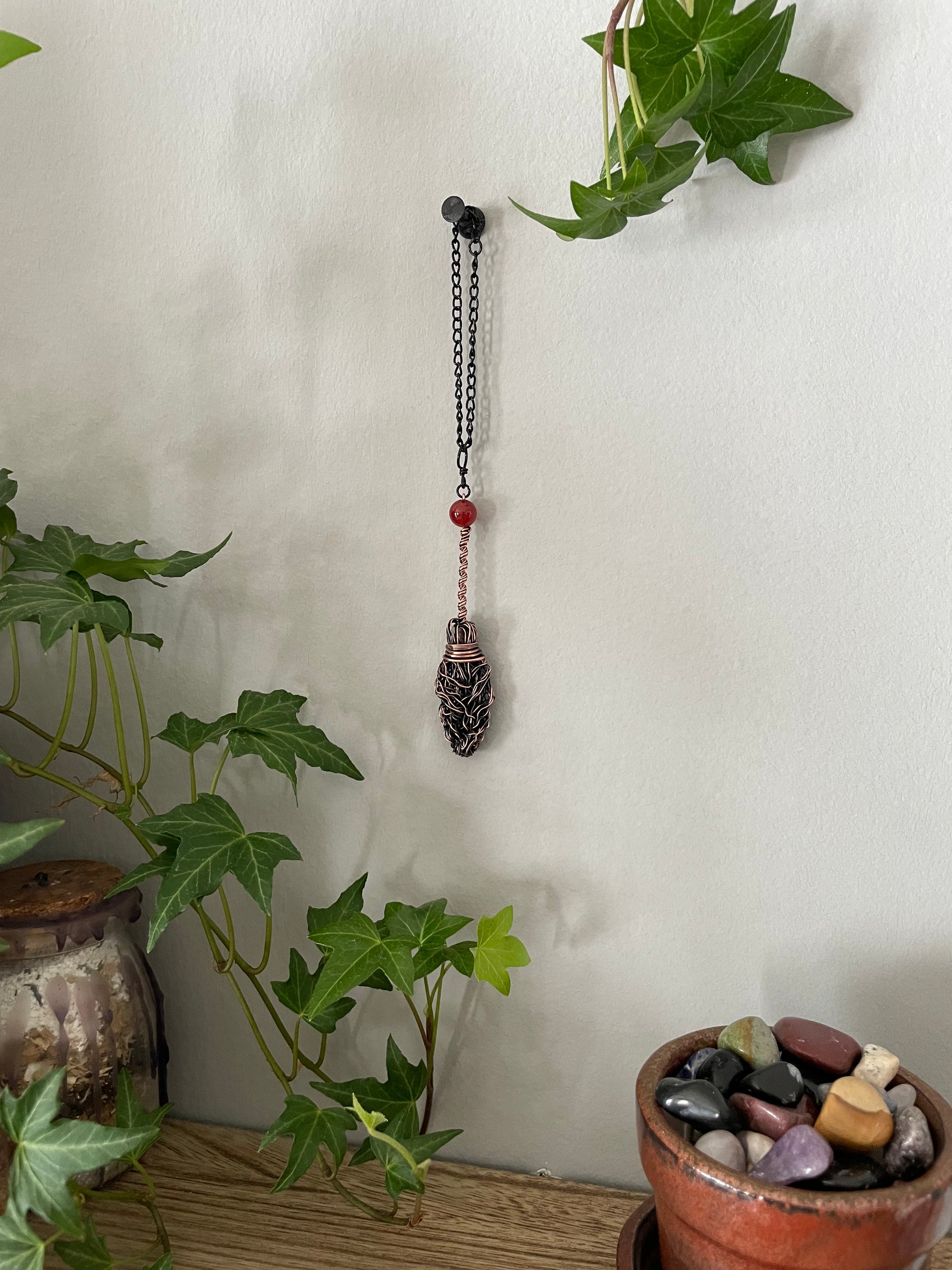 Image of miniature copper broom with carnelian bead