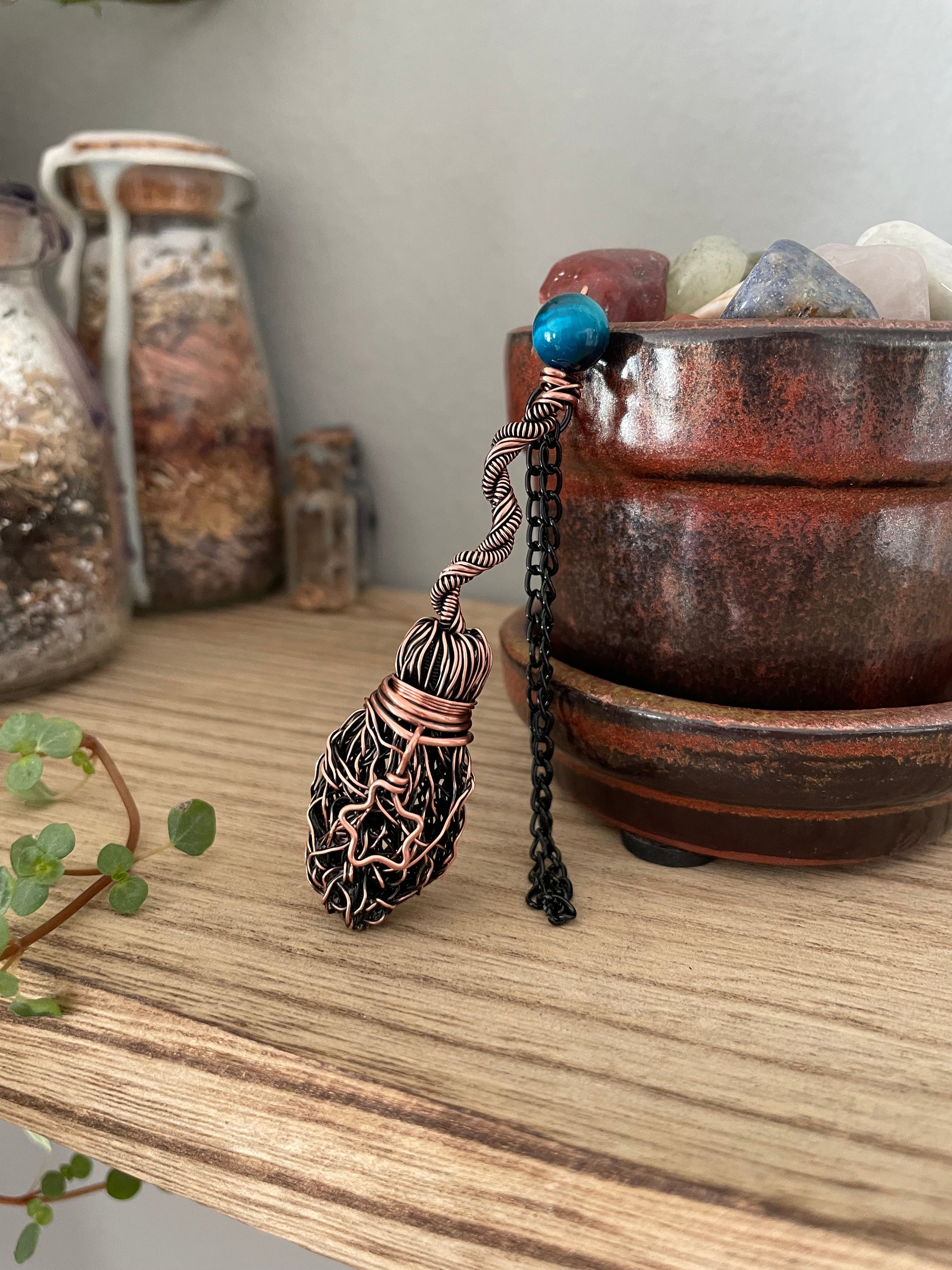 Image of miniature copper broom with blue tigers eye bead and star charm