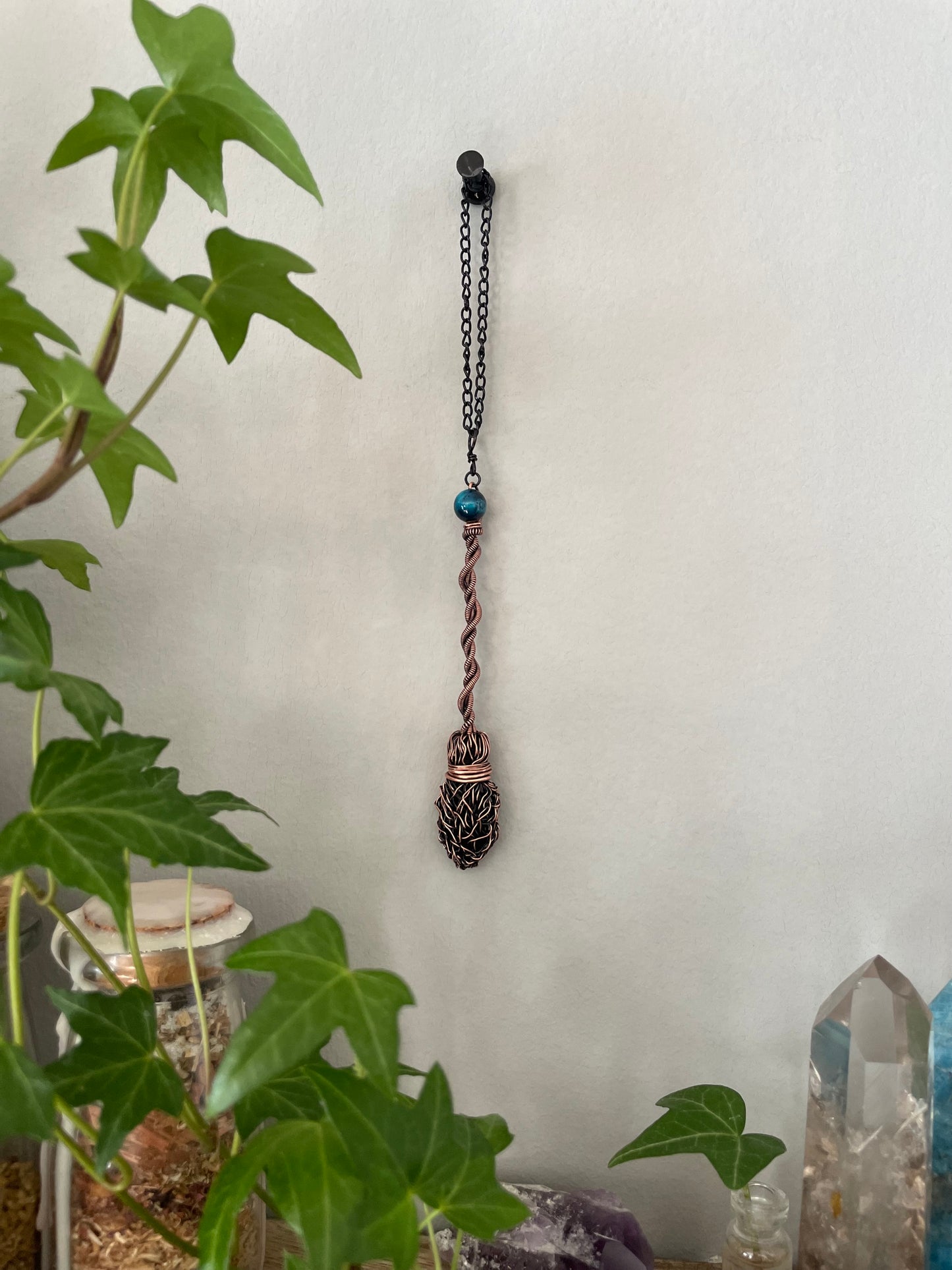 Image of a miniature wire broom with blue tiger's eye bead