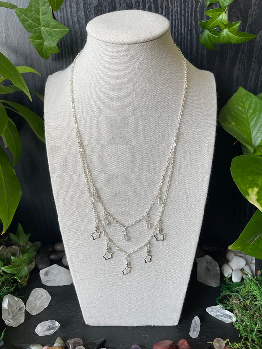 Necklace on a mannequin bust with a natural stone and crystal background