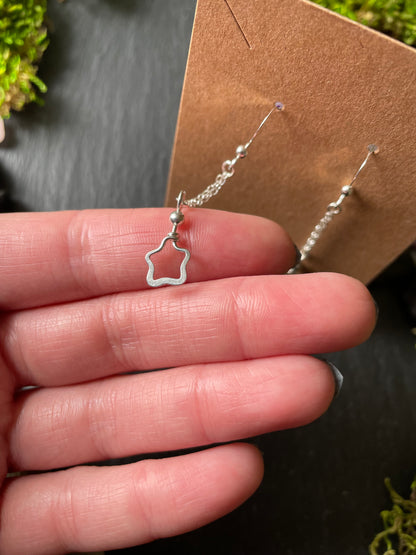 Image of silver star charm earrings