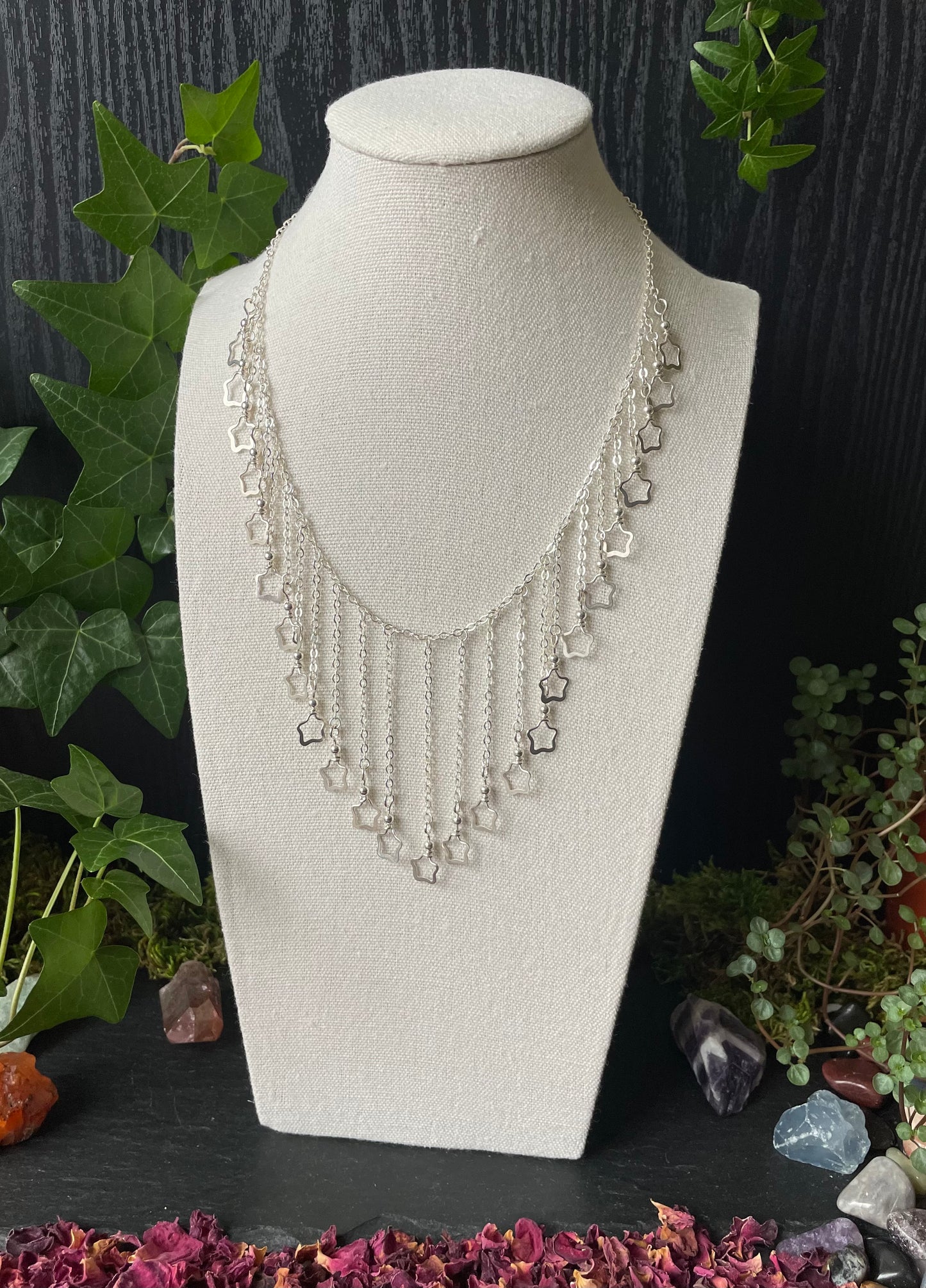 Image of a necklace with silver star charms