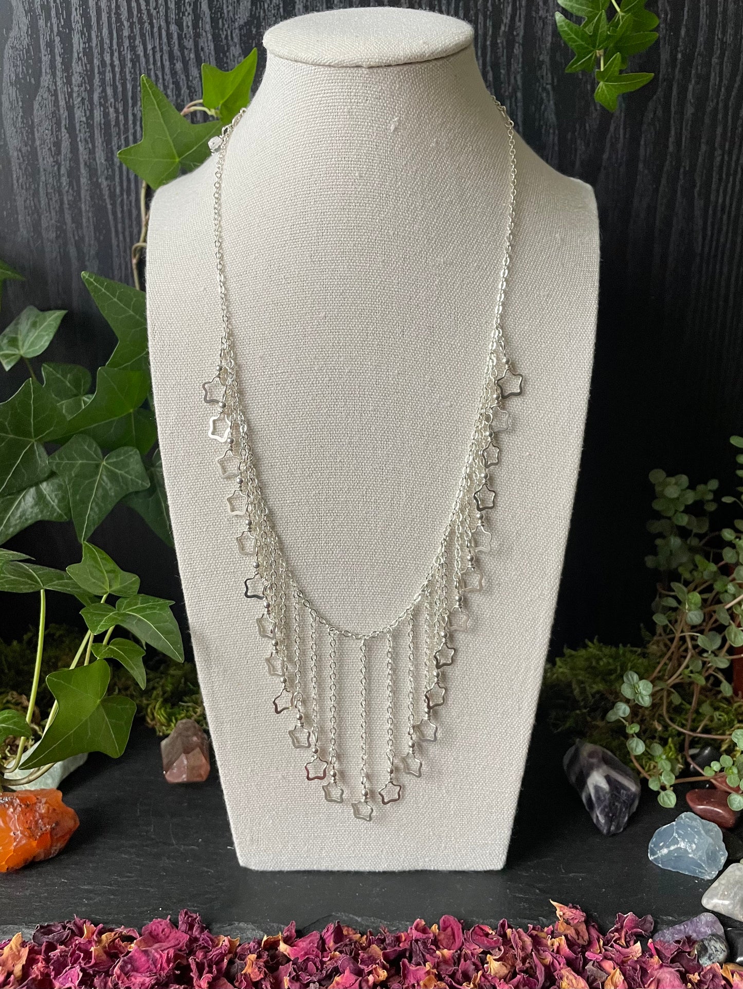 Image of a necklace with silver star charms