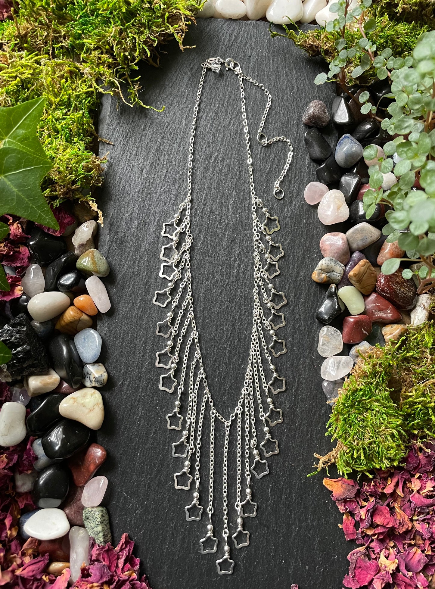 Image of a necklace with silver star charms