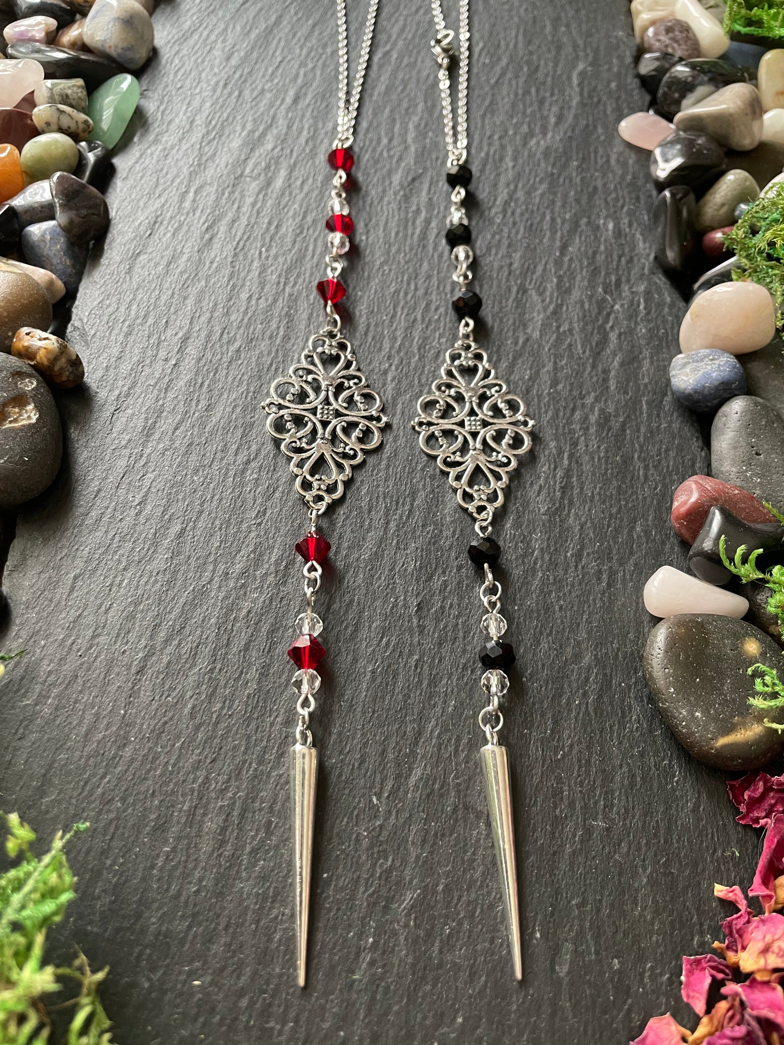 Two car charms with red and black beads and silver filigree design