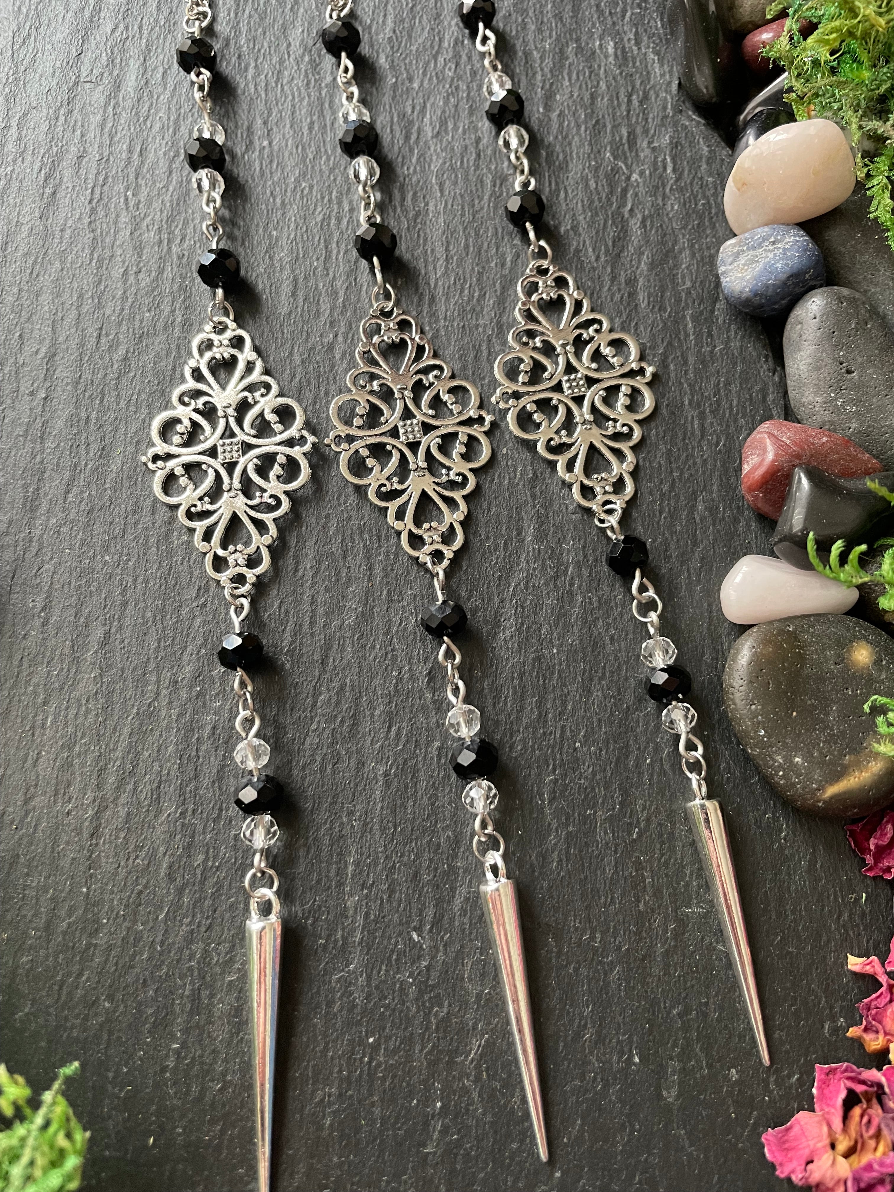 Decorative car charms with black beads and silver filigree design