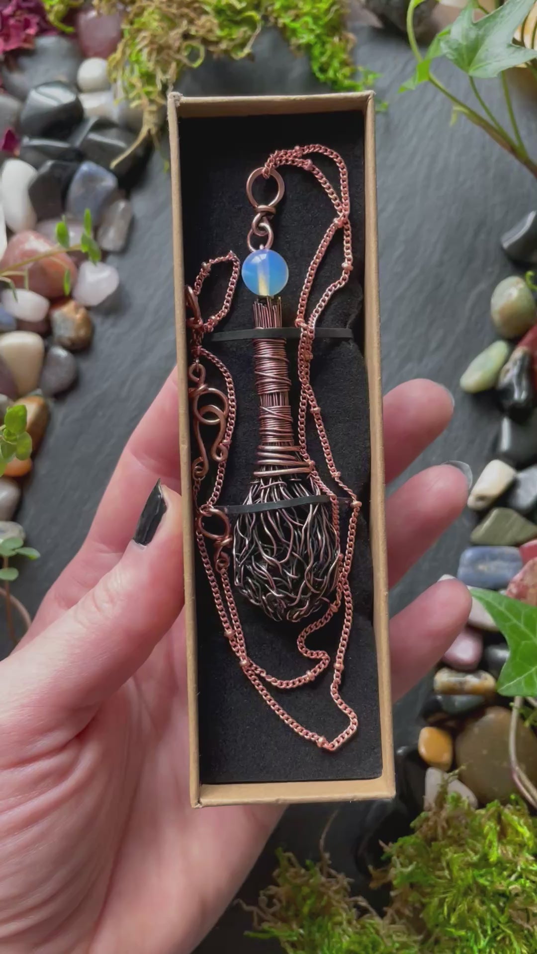 A miniature broom pendant with an opalite bead
