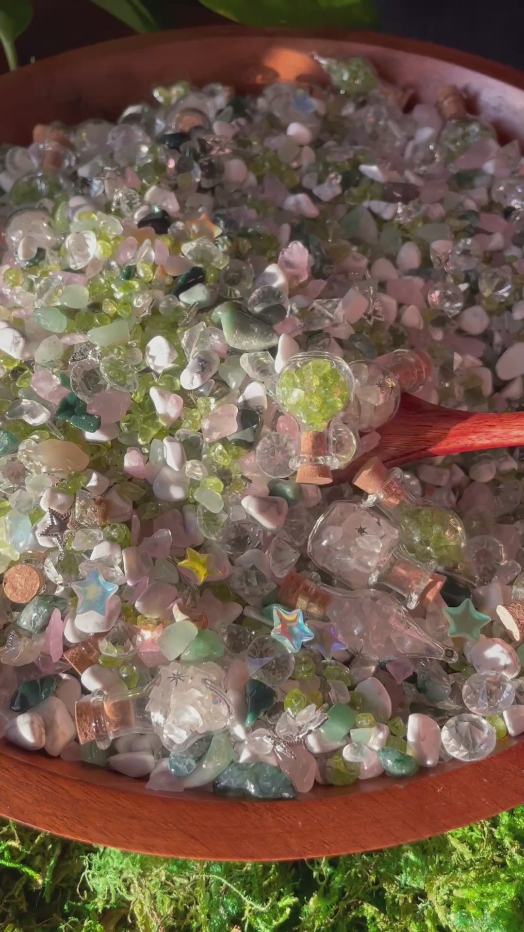 Spoon scooping colorful crystal chips out of wooden bowl