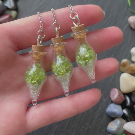 Mini glass vial plant charms with green peridot crystals and sparkles
