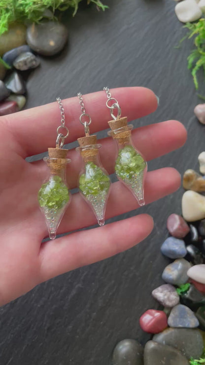 Mini glass vial plant charms with green peridot crystals and sparkles