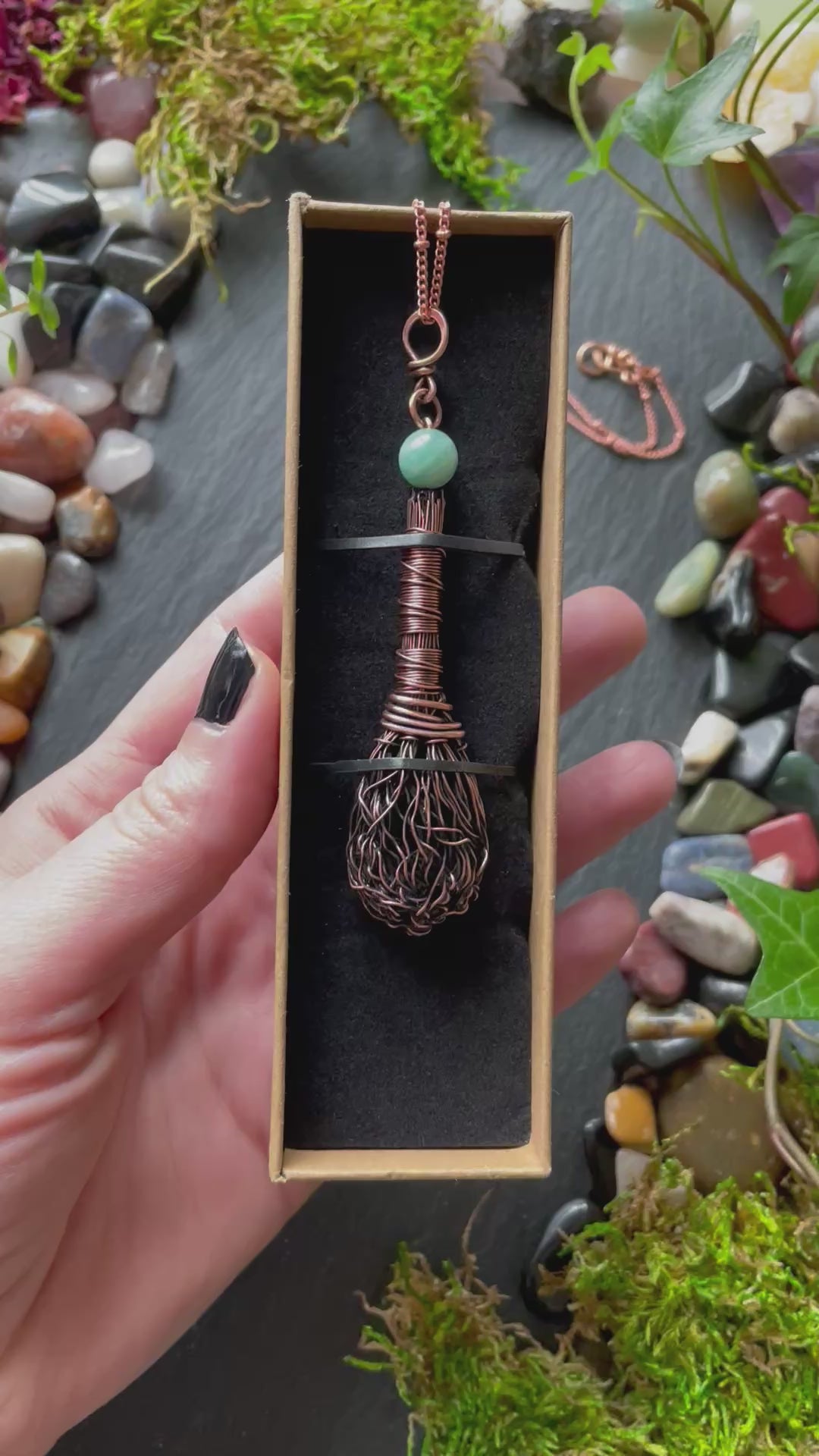 A miniature broom pendant with an amazonite bead