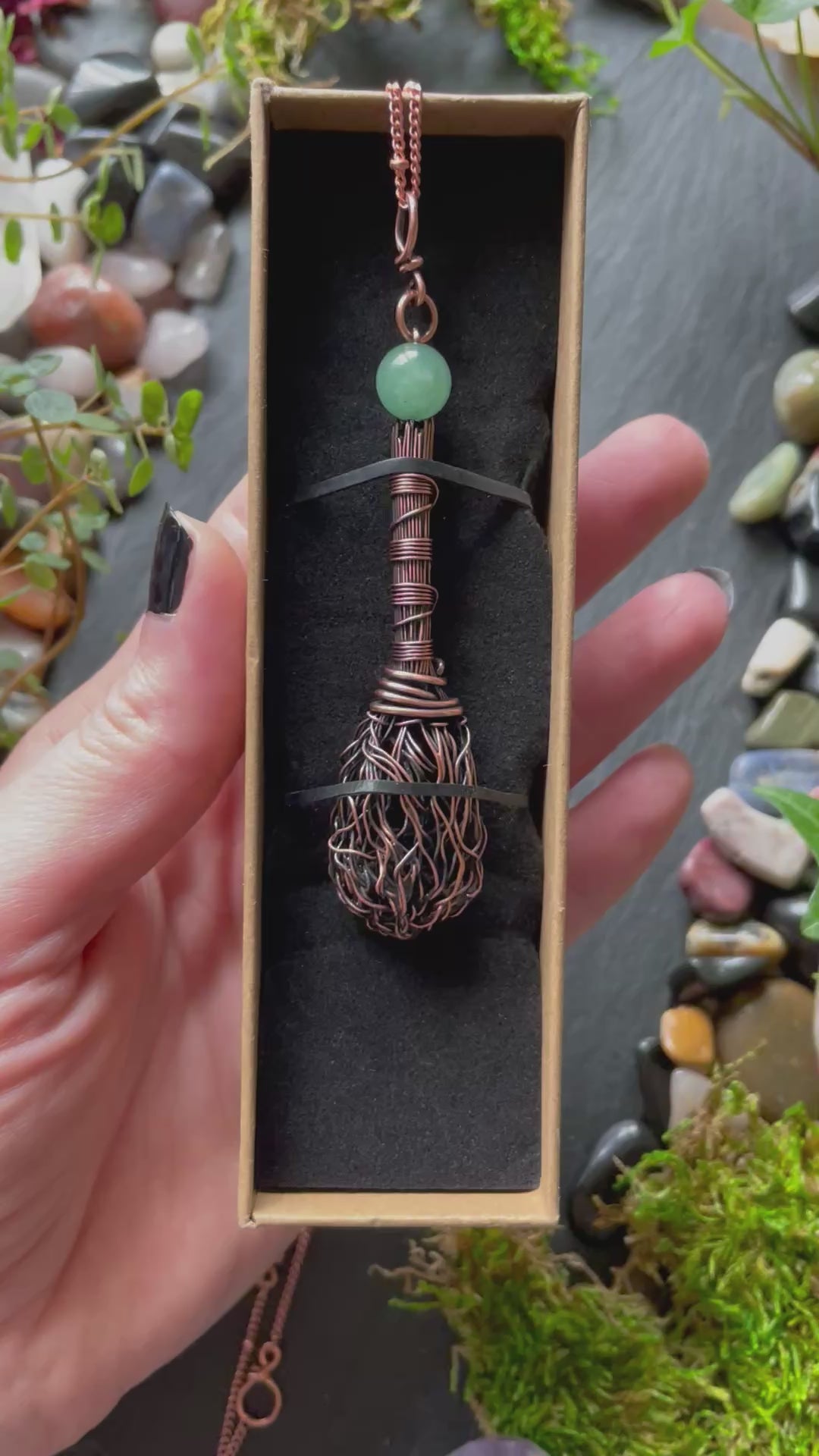 A miniature broom pendant with a green aventurine bead