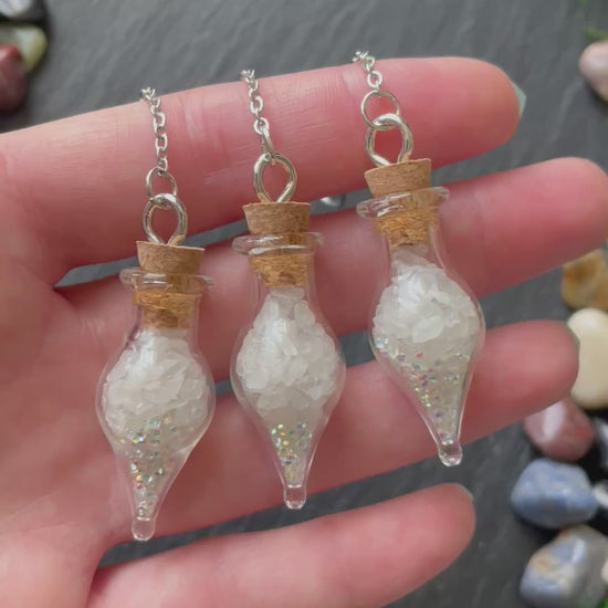 Mini glass vials filled with quartz crystals and sparkles