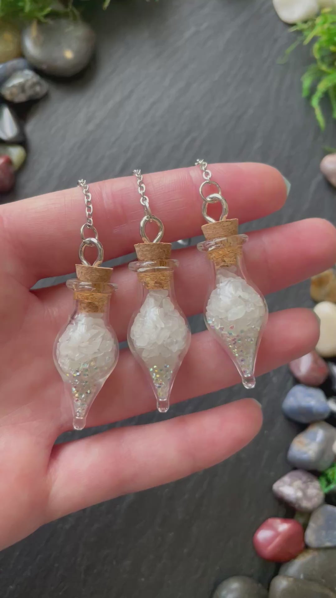 Mini glass vials filled with quartz crystals and sparkles