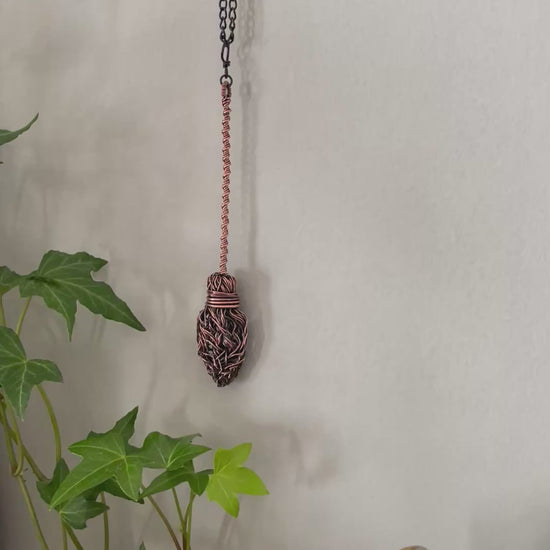 Video of miniature copper broom decoration on the wall