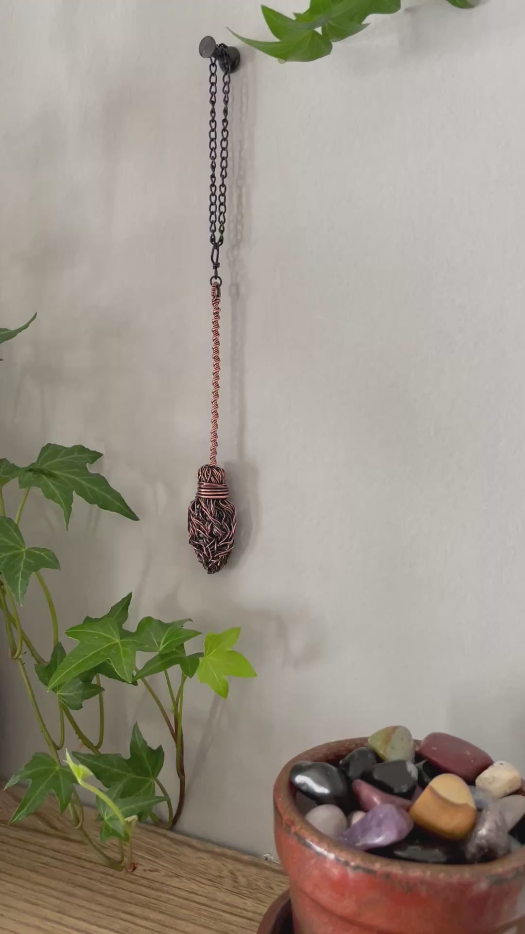 Video of miniature copper broom decoration on the wall